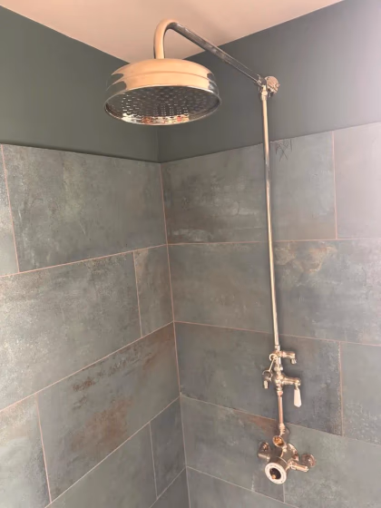 Modern shower installation with rainfall shower head and chrome fittings